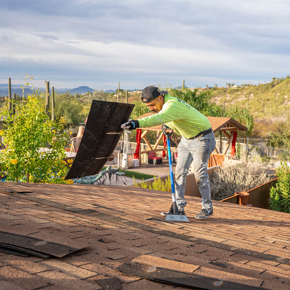 a roofing contractor helping repairing a roof